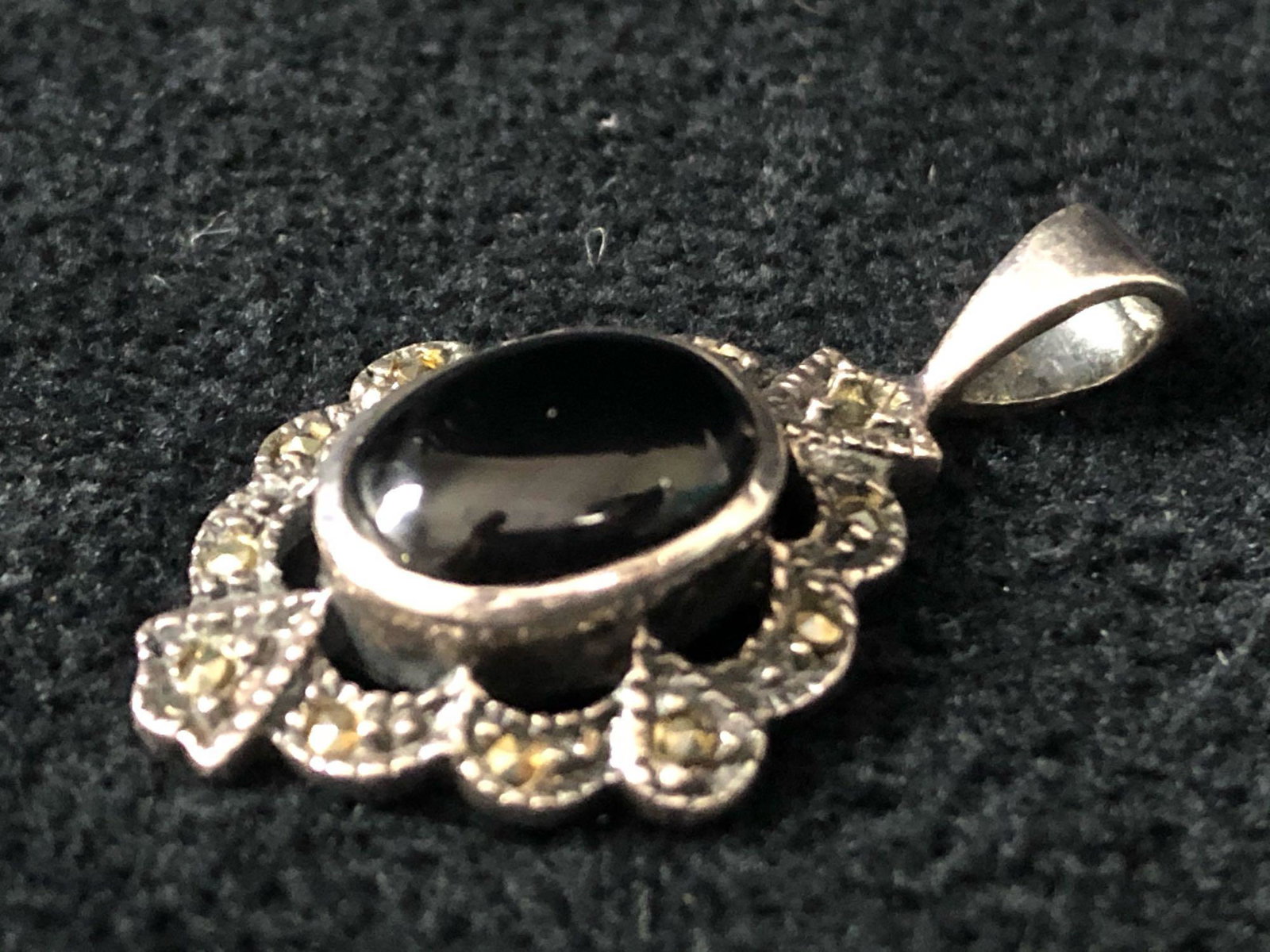 Vintage Sterling Marcasite & Onyx Pendant By HAN: Vintage Sterling handmade Marcasite & Onyx pendant by HAN. Made in Thailand. In very good condition with light scufs. Measurements approx 1 1/8" x 3/4". Weighs 3.81 grams.