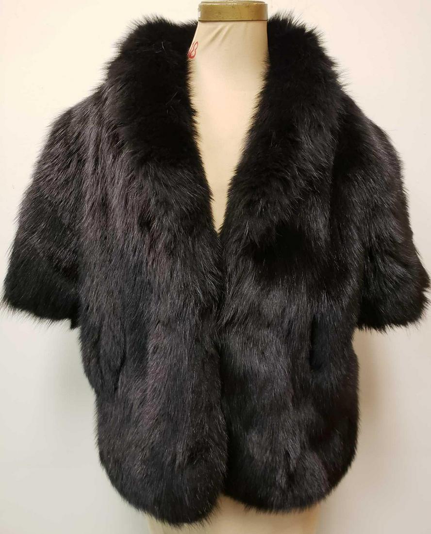 Black Dyed Fox Fur Mid Length Sleeve Jacket: Black Dyed Fox Fur Mid Length Sleeve Jacket. This jacket is in great used condition. The jacket has no known signs of damage to the interior or exterior. The jacket has a black fabric interior and hoo