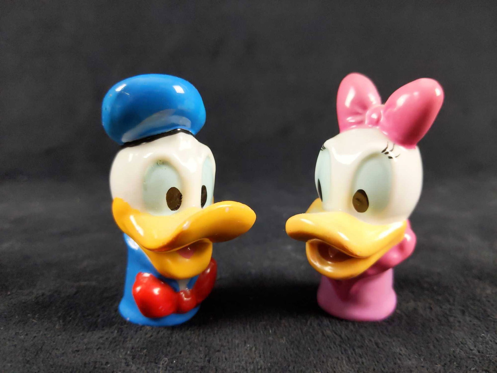 Daisy and Donald Duck Ceramic Porcelain Thimbles Set Of: Disney Daisy and Donald Duck ceramic thimbles by Enesco. This set of thimbles is in good used condition with some scuffing (please see pictures) . Year of manufacturing is unknown. They are a great sm