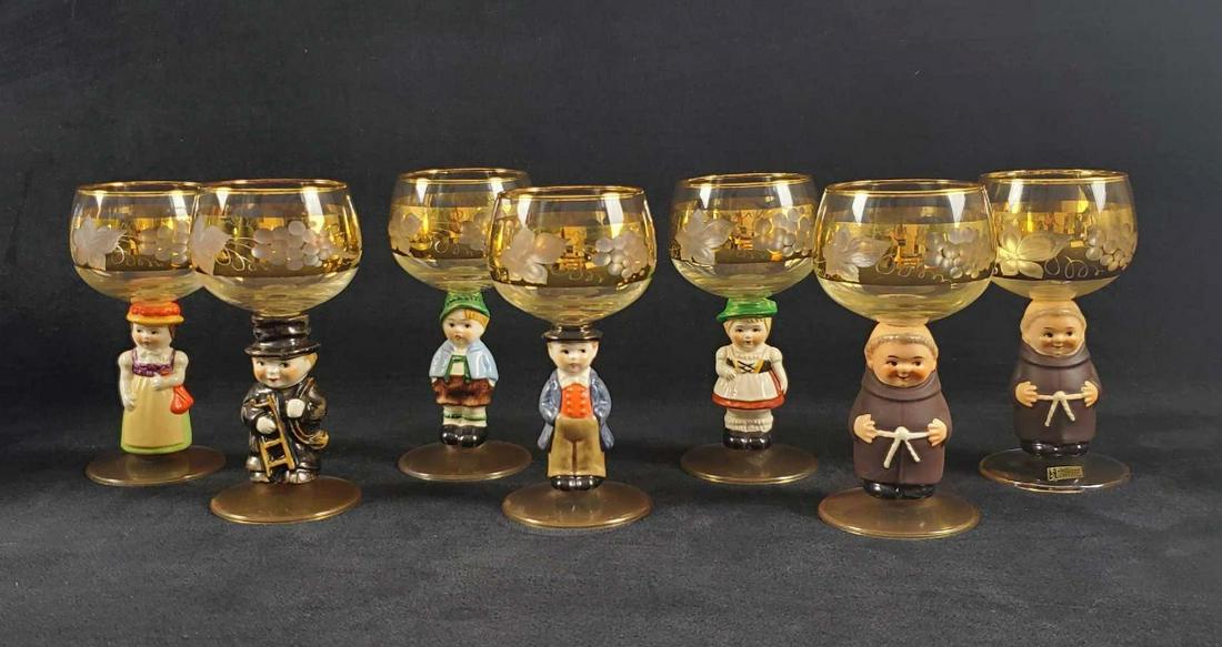 Set of Seven Goebel Hummel Wine Glasses: This a full set of the Hummel Goebel wine glasses plus one extra. This set consists of seven figurines: (2) Friar Tucks, (1) Bavarian Boy (1) Bavarian Girl (1) Black Forest Man (1) Black Forest Woman