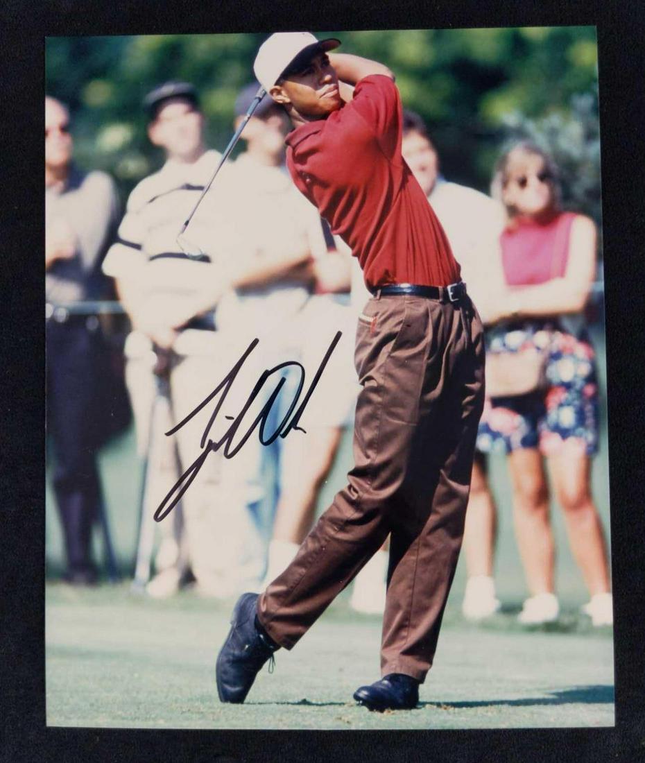 Autographed Golfing Great Tiger Woods Photo: Autographed publicity photo of the golfer, Tiger Woods. It also comes with a note saying the autograph was acquired at the "Sports Collector Show" in Arlington, Texas. Please note, this does not come 