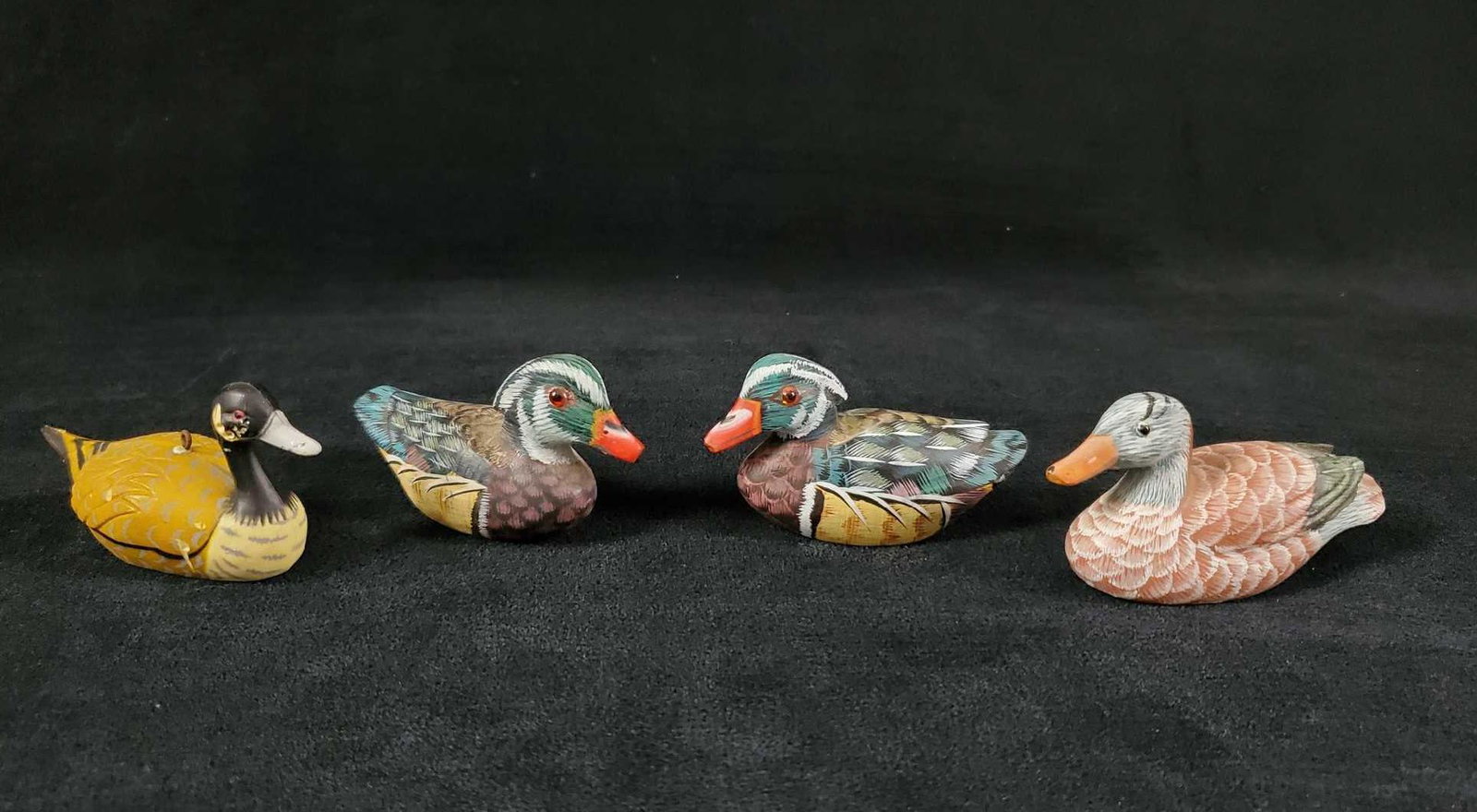 Lot Of Four Hand Painted Mini Ducks And Goose: This lot includes: (3) Hand carved and hand painted light wooden (could be a basswood) ducks with acrylic eyes. These are in good, vintage condition with only light wearing on ducks. There appears to 