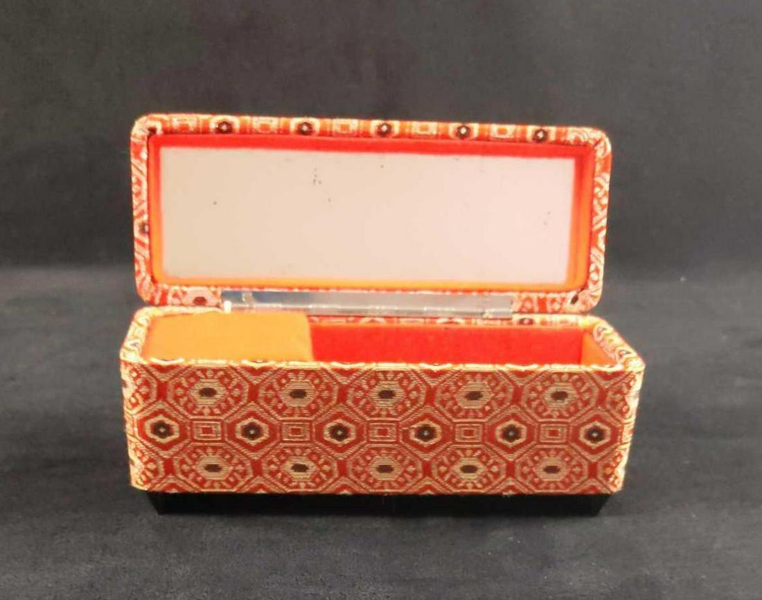 Vintage Jewelry Box With Mirror And Music Box: Vintage jewelry box with mirror and music box. The box is covered with a coral. black and white pattern. Maker and date of creation is unknown. The box opens to a song (not sure what it is) a section 