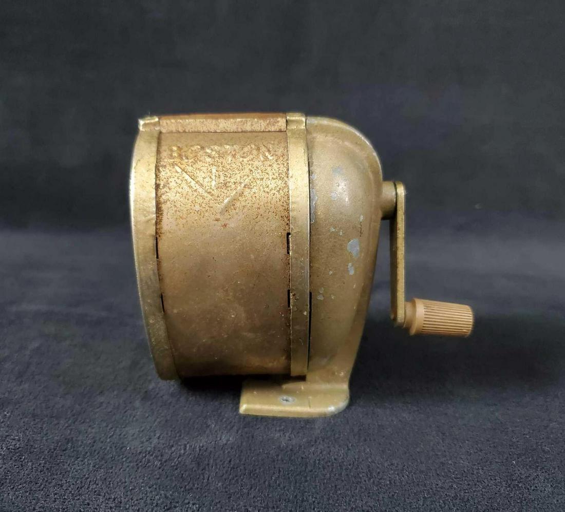 Vintage Hand Crank Pencil Sharpener: Vintage hand crank pencil sharpener is a Boston L has a wall mount or desk mount base. The shaving catch rotates freely. It is in good used condition with a functioning crank.There is some rusting, ch