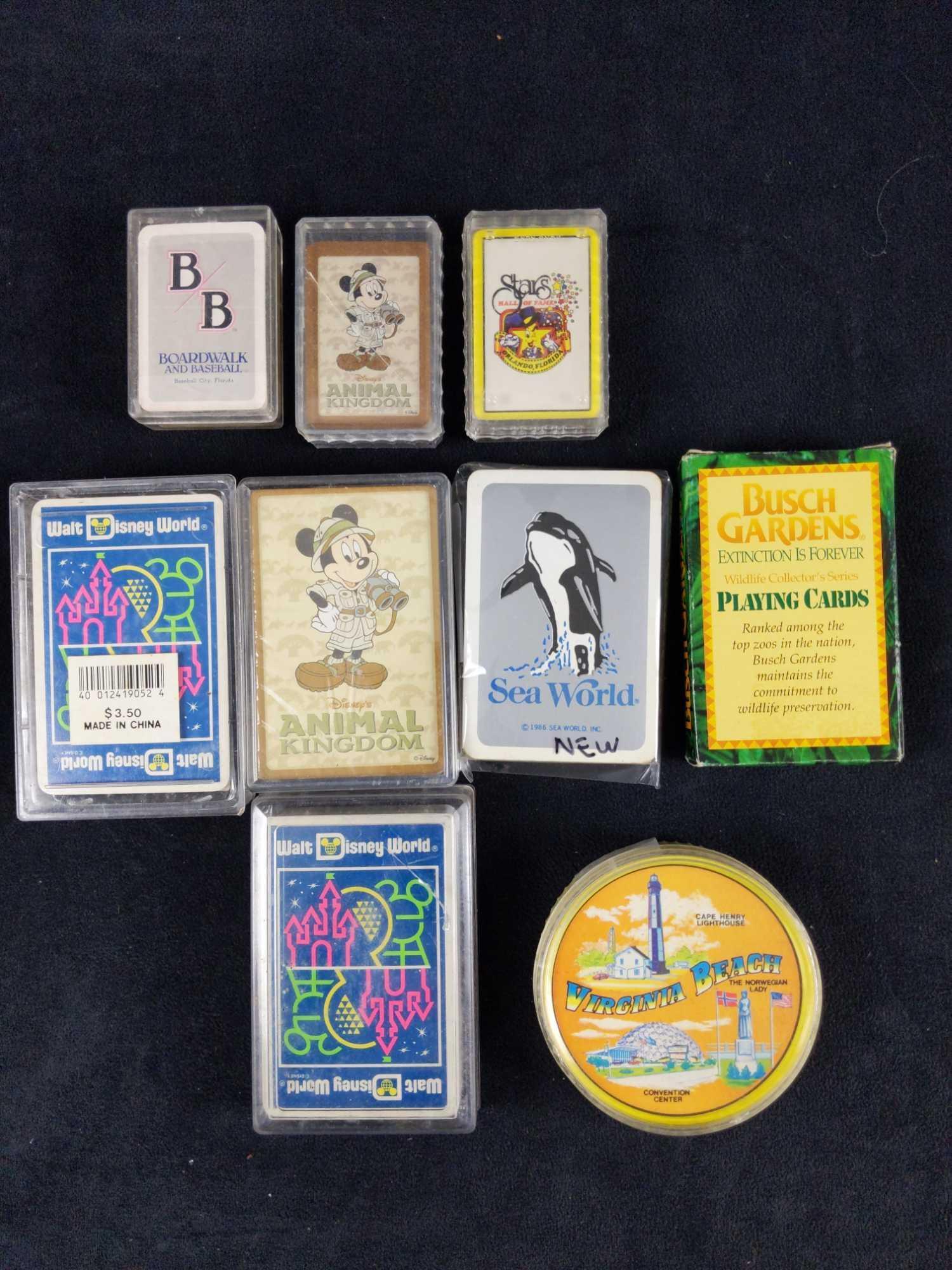 Nine Theme Amusement Park Playing Card Decks Disney: This lot consists of: (2) Walt Disney World Plastic Coated Playing Cards In A Plastic Case. Shows different park's logos (this was before Animal Kingdom opened). One set is open, one is still in its o