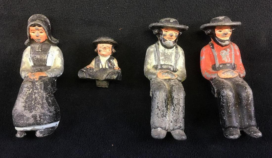 Molded Lead Amish Figurines: Molded Lead Amish Figurines. These figurines are in fair condition. It looks as though they are missing the original carriage or bench they are meant to sit on. The paint on the figures is chipping aw