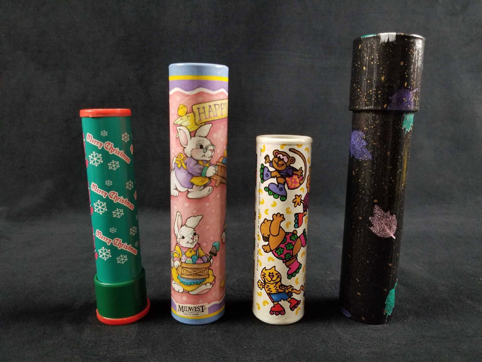 Lot of 4 Late 90s to Early 2000s Children Kaleidoscopes: Lot of 4 Late 90's to Early 2000s' Children Kaleidoscopes. This lot consist of: (1) Happy Easter. Outside exterior depicts pastel colors of a white Easter bunny painting eggs. Manufactured by Midwest 