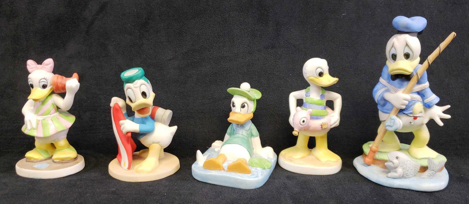 Lot of 5 Walt Disney Productions Donald and Daisy Duck: Lot of 5 Walt Disney Productions Donald and Daisy Duck Beach Ceramic Figurines. This lot of Donald Duck figurines is in good used condition. The figurines have no known signs of chips or cracks in the