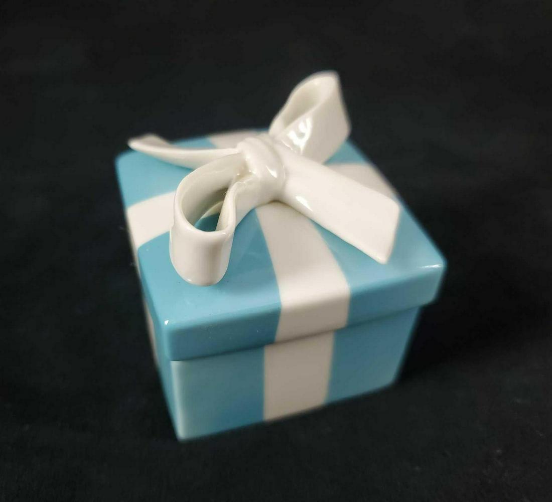 Porcelain Tiffany Blue and White Trinket Box: This blue and white trinket box made from porcelain marked Tiffany and Co. is in very good condition with no known damages such as chips, cracks or crazing. Measures approx 2 1/4" x 2 1/4" x 2 1/4".