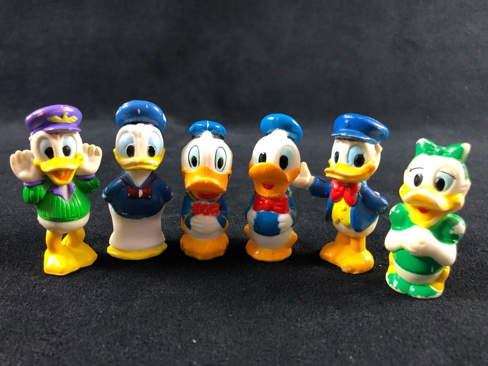 Lot of 6 Donald Daisy Duck Miniature Plastic Figurines: Lot of 6 Donald Daisy Duck Miniature Plastic Figurines This lot features an exciting display of Donald and Daisy in different outfits and poses. Great for display in your office at work or at home. In