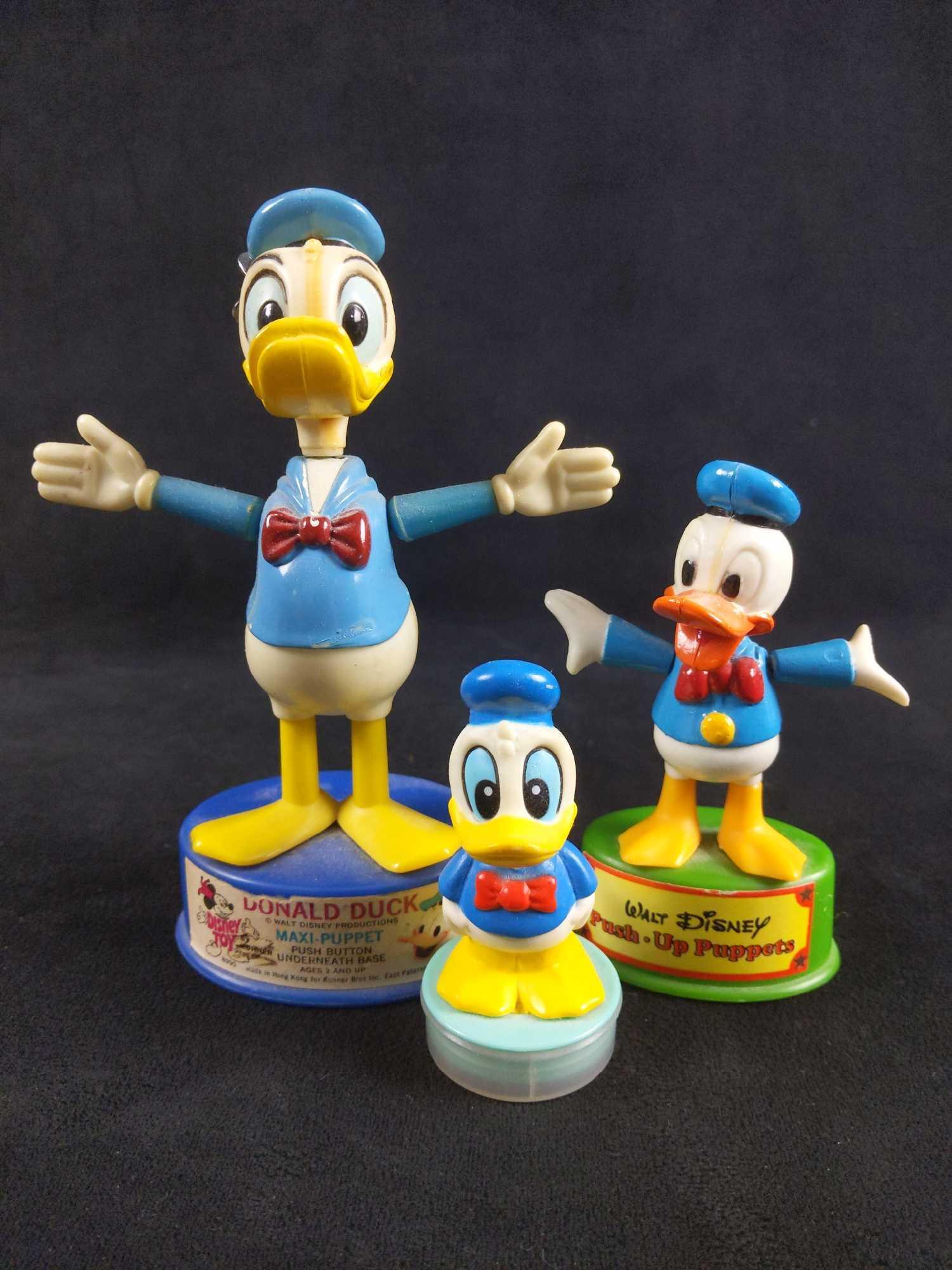 Donald Duck Collectible Push Up Puppet Stamp Lot of 3: 1) Walt Disney Push-Up Puppets. This toy is very fun because you push the button underneath the base and Donald's whole body collapses then straighten back up when button is released. This toy feature