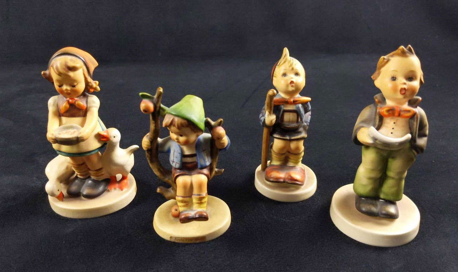 Mini Hummel Figurines Lot Of Four B: Here is a lot of four mini Goebel Hummel Figurines made in West Germany during the '60s/70's. Hand-painted porous earthenware. This lot includes: (1) Apple Tree Boy. TMK-3. Is approx 2" x 4". It is in