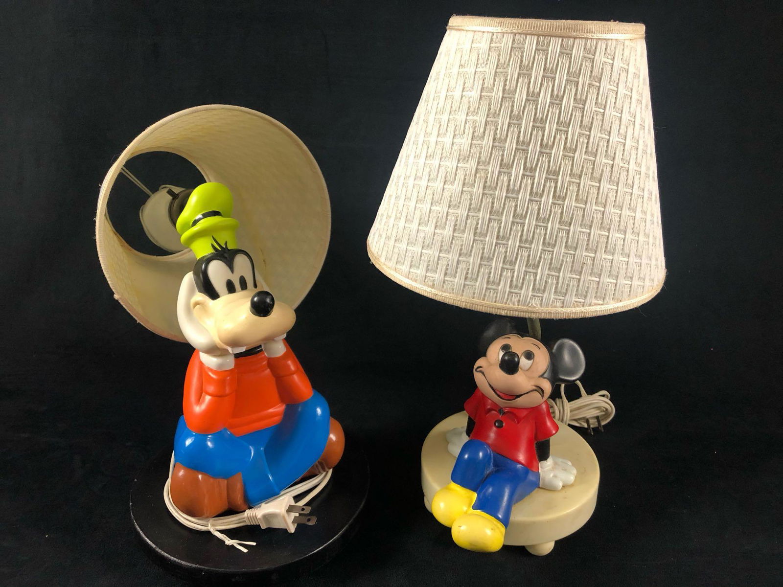 Vintage Mickey & Goofy Table Lamps: Vintage Mickey & Goofy Table Lamps.This lot is in good working condition with some scuffs and damaged shades ( easy to replace ) . Mickey lamp is 16" tall Goofy is 10" tall both use standard bulbs .