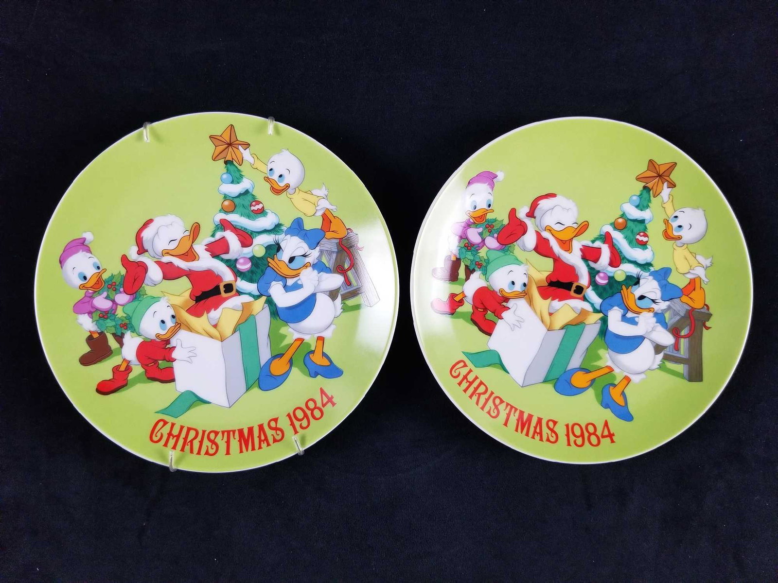 A Lot of 2 Christmas 1984 Plates Limited Edition Walt: A Lot of 2 Christmas 1984 Plates Limited Edition Walt Disney Celebrating Donald Duck's 50th Birthday Duck family Christmas portrait with Huey, Dewy and Louie, Daisy Duck. The plates are in excellent c