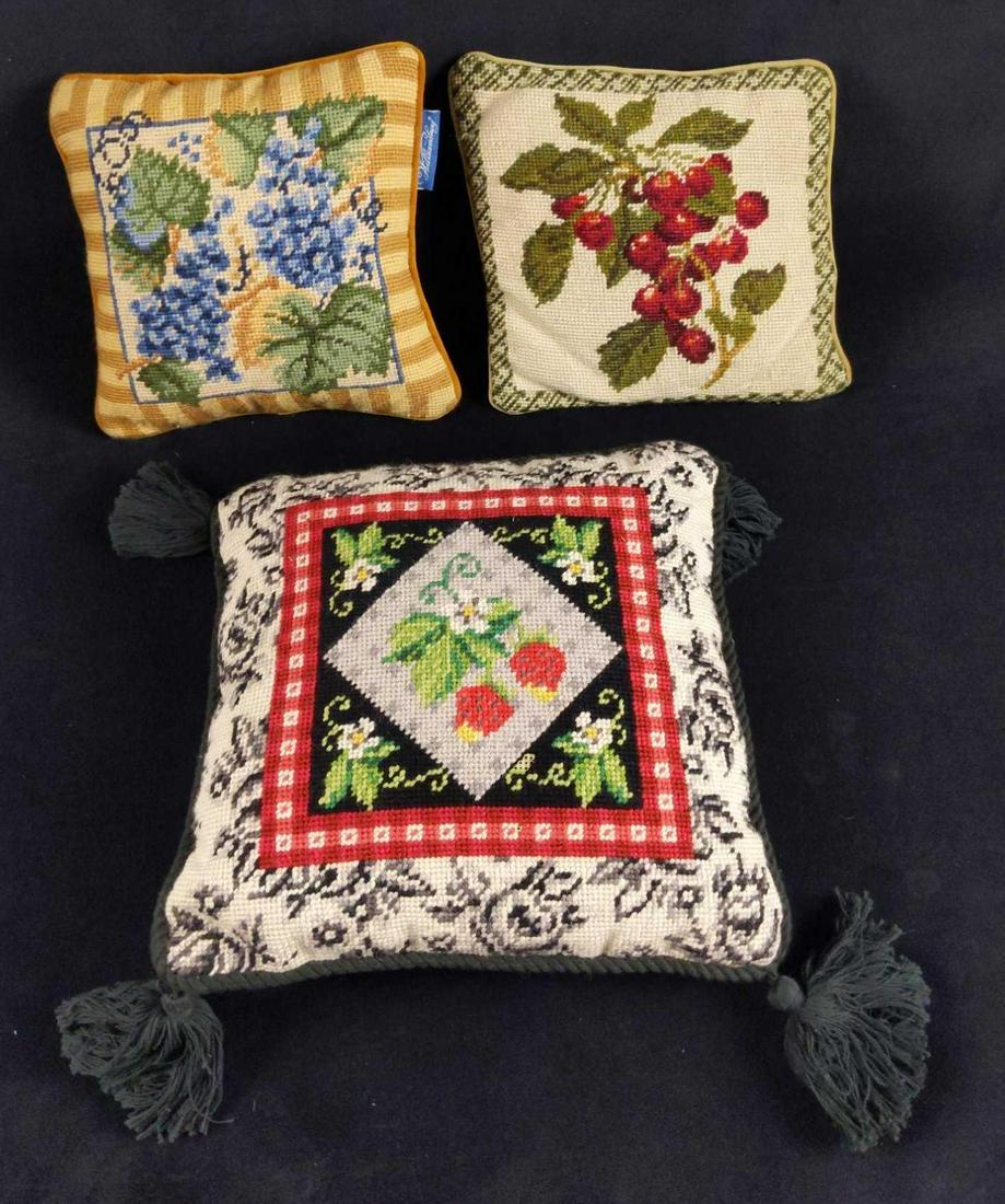 Three Fruit Themed Needlepoint Throw Pillows: This lot includes: (1) Grape (By Williamsburg) Throw Pillow. Pillow is approx 9" x 9". Is in good, used condition with some wearing on the pillow. (1) Strawberry Throw Pillow. Is approx 11" x 11". The