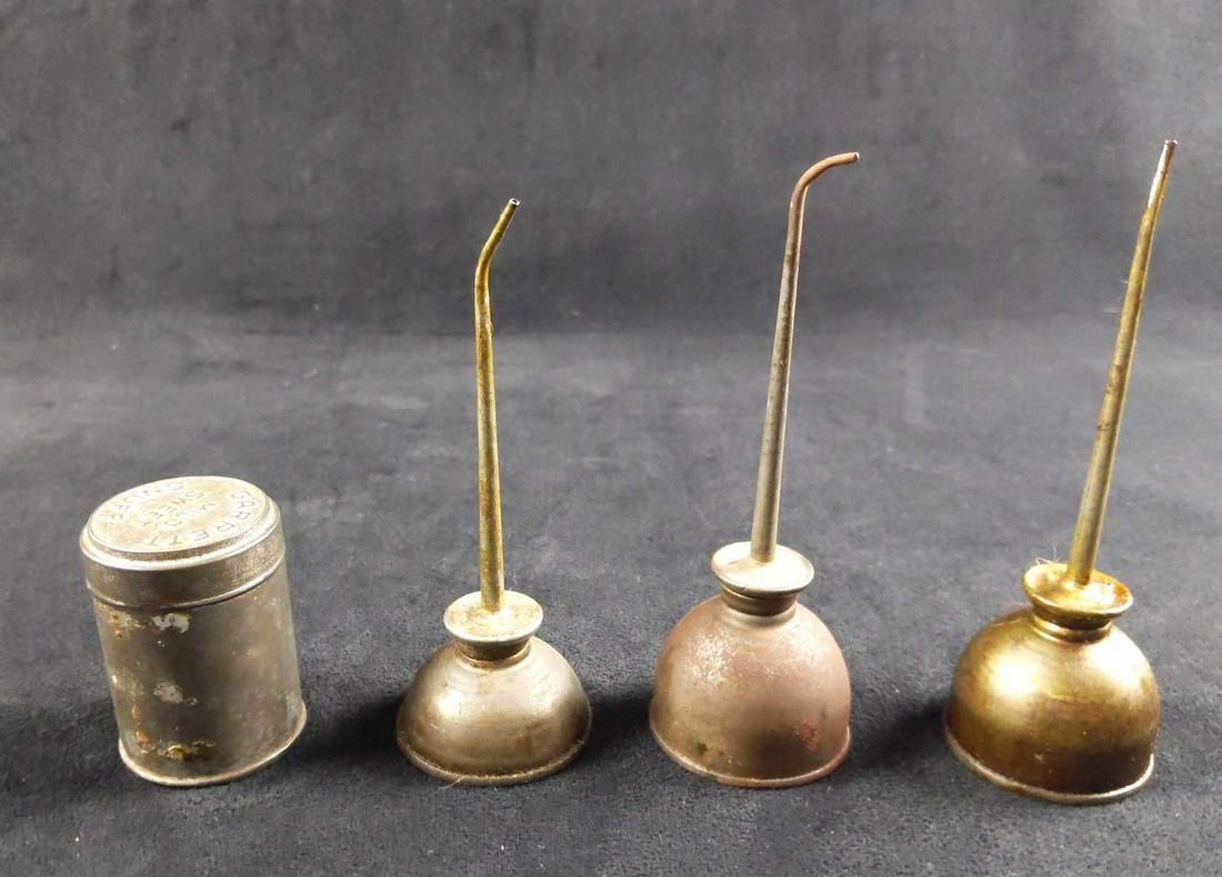Vintage Oil Cans And Garrett Mild Sweet Snuff Tin: This lot includes: (1) Brass Oil Can. Is approx 2" x 2" x 6". It is in good, vintage condition with some light tarnish and wearing. It also has some remaining oil left on can. (2) Metal Oil Cans. Is a