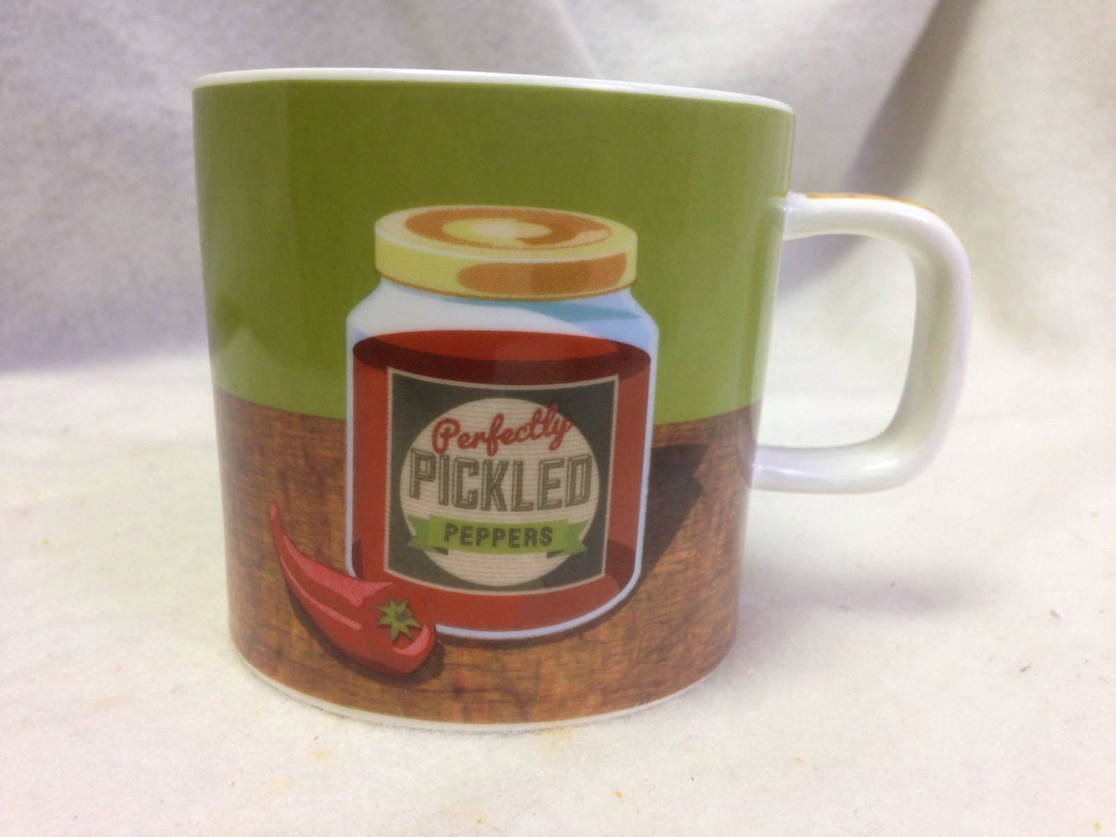 Novelty Coffee Mug: "Perfectly Pickled Pepper" coffee mug. condition: Excellent. Size: 3.25". Maker: Typhoon (microwave safe). Other Info: Souvenir, Travel, Southwest, Tourist