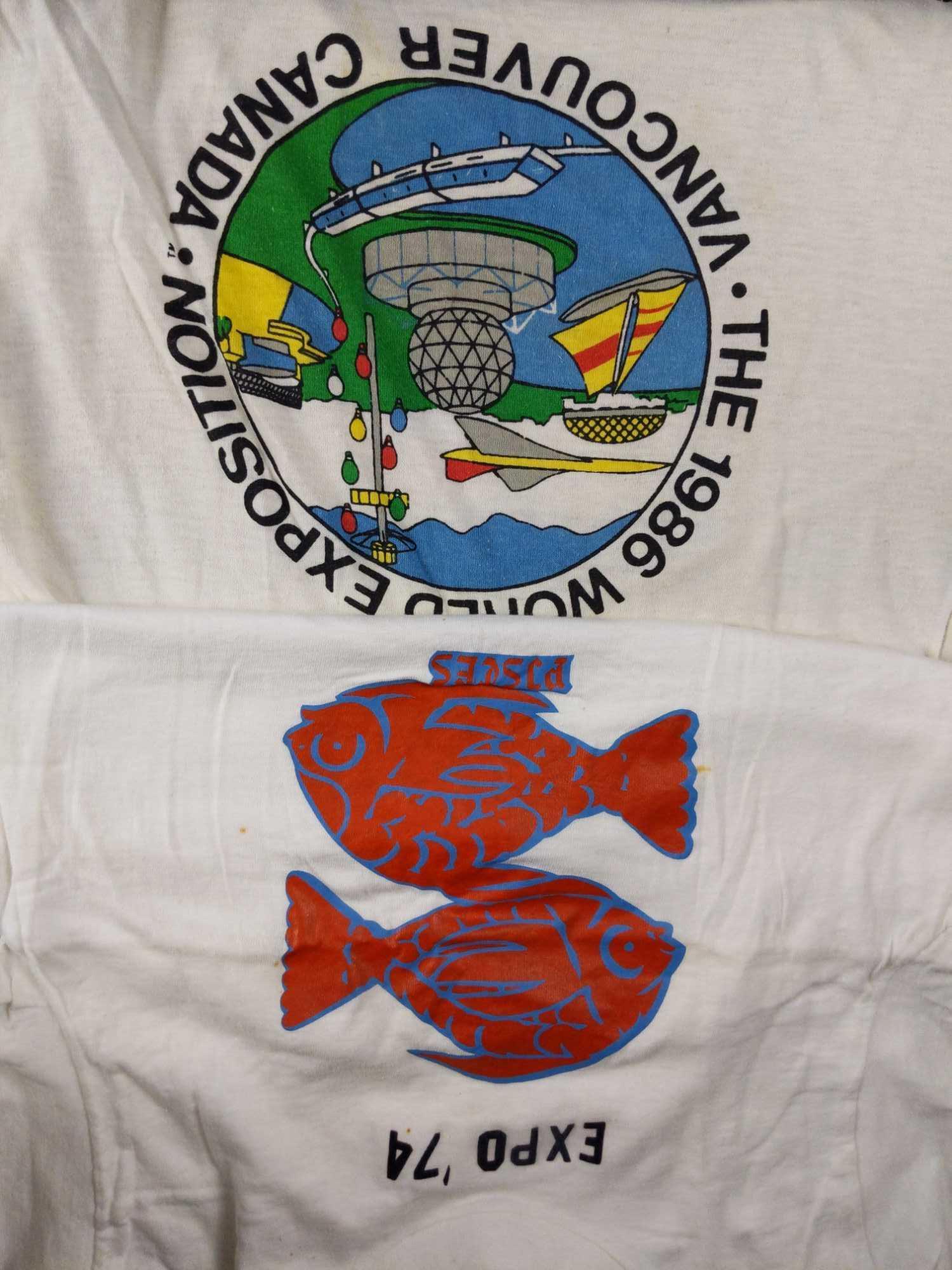 2 Vintage Worlds Fair T Shirts Small Large: This lot includes: (1) 1986 World Exposition on Transportation and Communication. Vancouver, Canada. large 67% Polyester/33% Cotton. The shirt is in good. vintage condition with some discoloration. (1