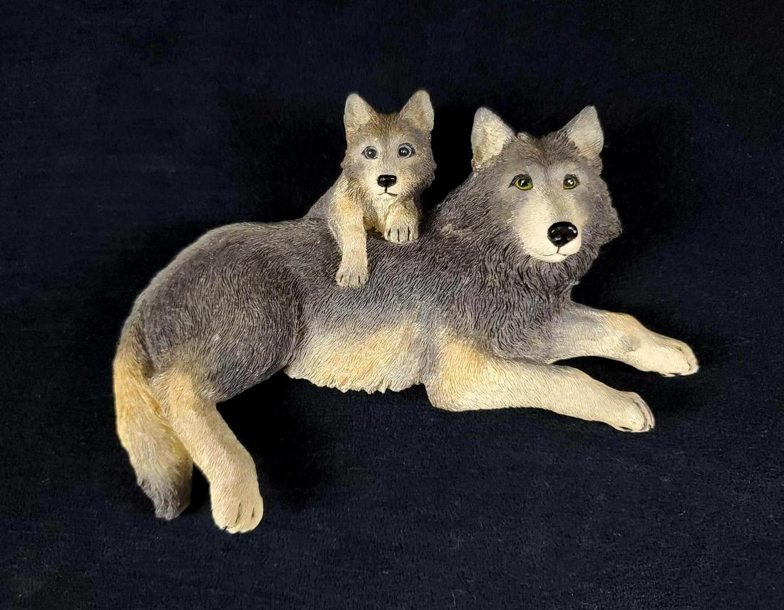 Wolf and Cub Shelf Sitter by Crossroads: Wolf and cub shelf sitter by Crossroads. This sculpture is designed to hang over the edge of a shelf with Velcro attachment for reinforcement. The wolves face the right side. Executed in wood resin an