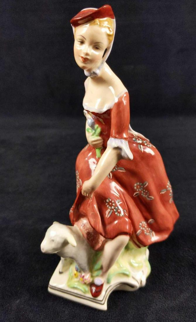 Vintage Wedgwood Shepherdess Hand Painted Figurine: A well dressed lady is interrupted by a cheeky little lamb. Hand painted figure is made by Wedgwood of England. Is approx 3" x 2" x 7". Figure is in good, vintage condition with petite marks and and a