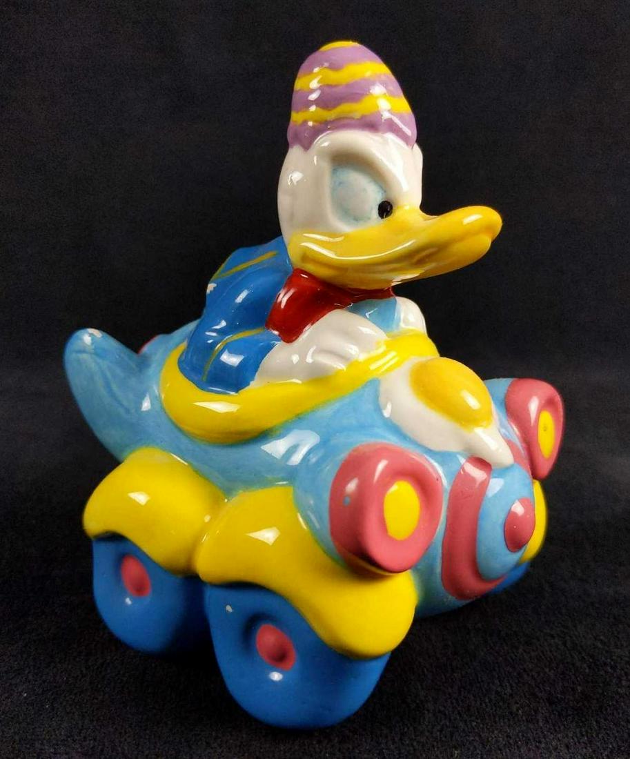 Disney Donald Duck Easter Egg Car Airplane Figurine: Disney Donald Duck Easter ceramic collectible figurine by ENESCO. This figurine is in good used condition with minimal signs of wear and tear. There are two small chips on the back of the figurine whe