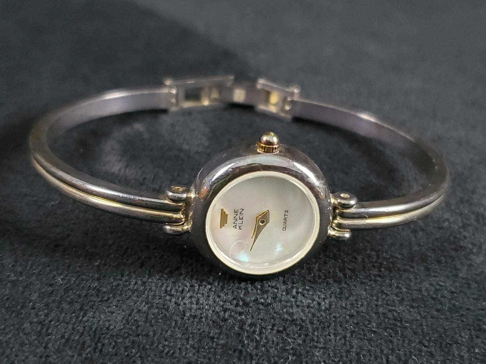 Vintage Anne Klein Quartz Pearlescent Bracelet Watch: Vintage Anne Klein Quartz Pearlescent Bracelet Watch. This watch features Japan Movement, base metal bezel, stainless steel back, and a fold over clasp for closure. In good used condition with some sc