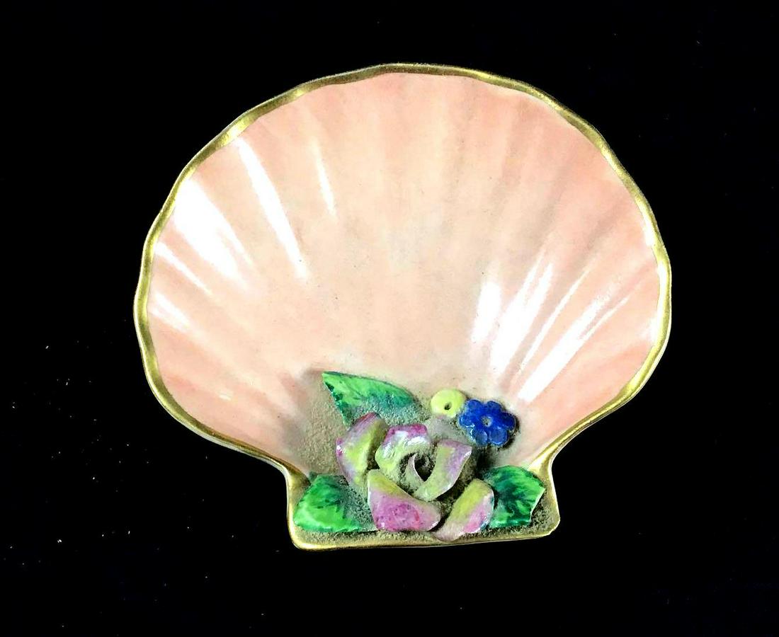 Vintage Circa 1900s Hand Painted Porcelain Shell: The base color is coral with colorful flowers at the "hinge" of the shell. The bottom says hand painted the artist name is illegible. The lip is gold colored. It is in good condition with some known w