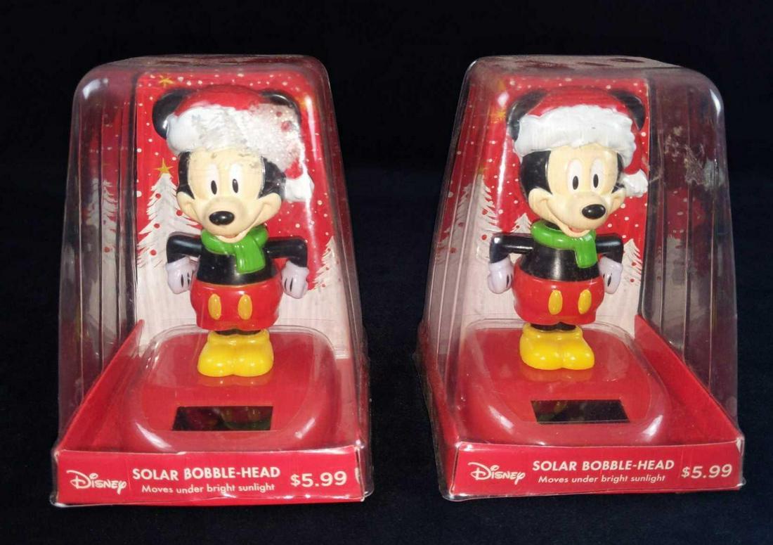 Disney Mickey Mouse Christmas Solar Bobblehead: Two Mickey Mouse Santa Solar Bobbleheads. No need to be flicky with Mickey, the vast powers of the sun will activate Mickey into Bobblehead mode! Our pal Mickey is festooned with a Santa hat and scarf