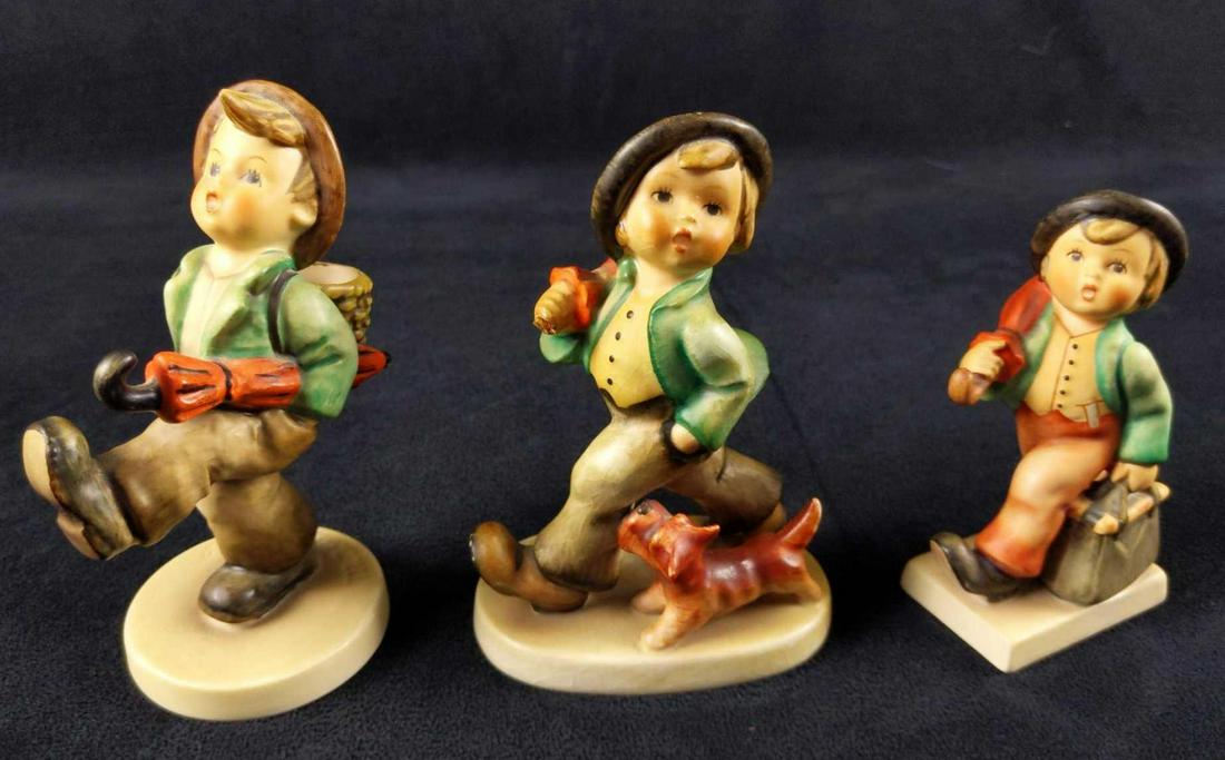 Vintage Goebel Hummel Wandering Boy Lot Of Three: This lot includes: (1) Happy Traveler 79 HUM. TMK 6. Is approx 2" x 2" x 5". (1) Strolling Along 5 HUM. TMK 3. Is approx 3" x 2" x 5". Umbrella is damaged. (1) Merry Wanderer 11 2/0. TMK 6. Is approx