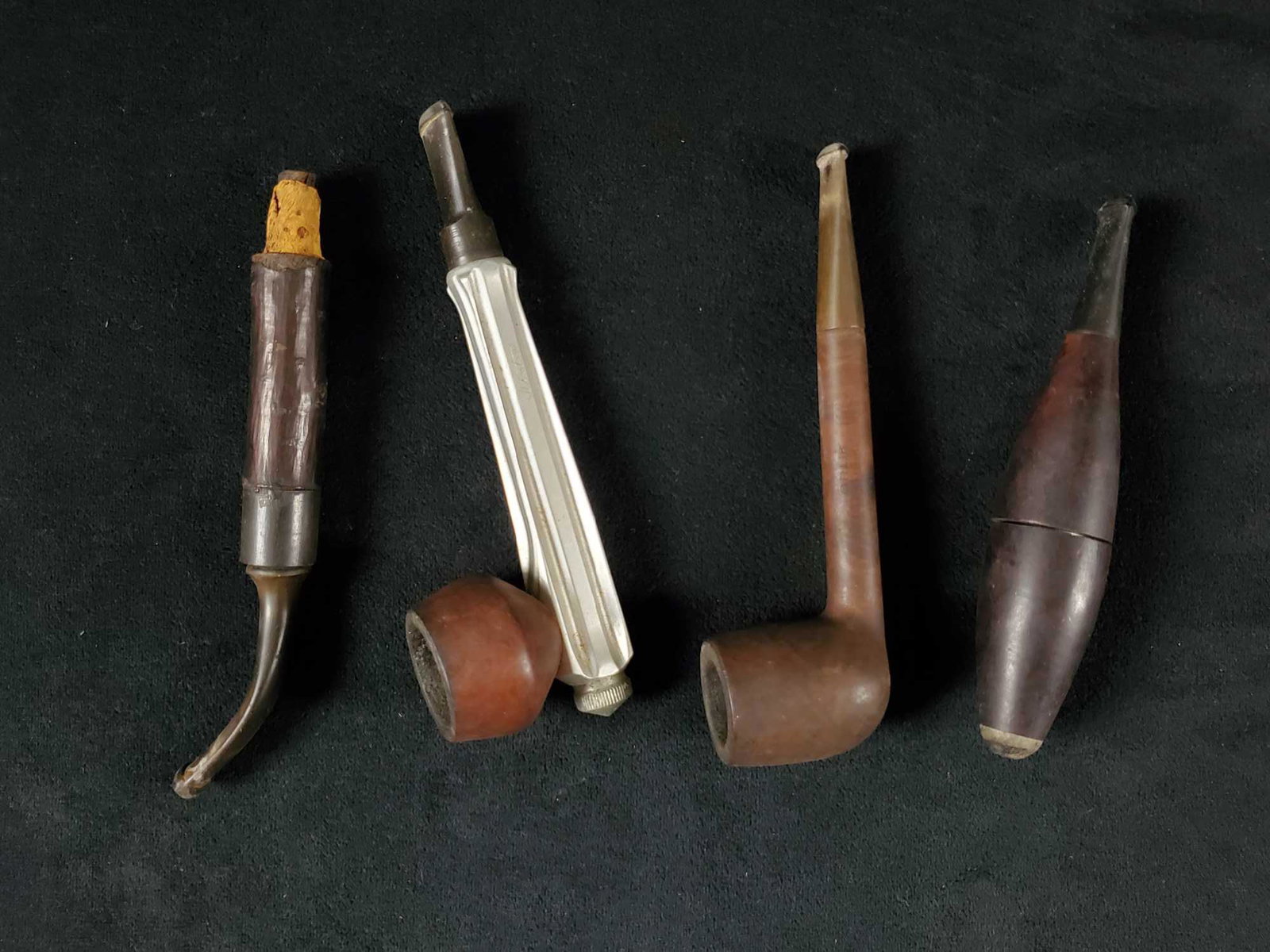 Midcentury Tobacco Smokers Pipes Kirsten Bakelite: (1)This hand carved wooden pipe is made by an unknown manufacturer and date but features a unique shaped shank that curves upward. It is at least 50 years old. It is in fair condition as the connectin