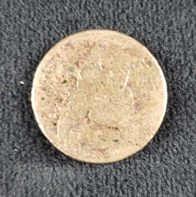 1857 Penny: 1857 Penny. This penny is in fair condition. The penny has some signs of wear on the front and back. The front of the penny's design is largely worn away but it depicts an eagle in flight and the back