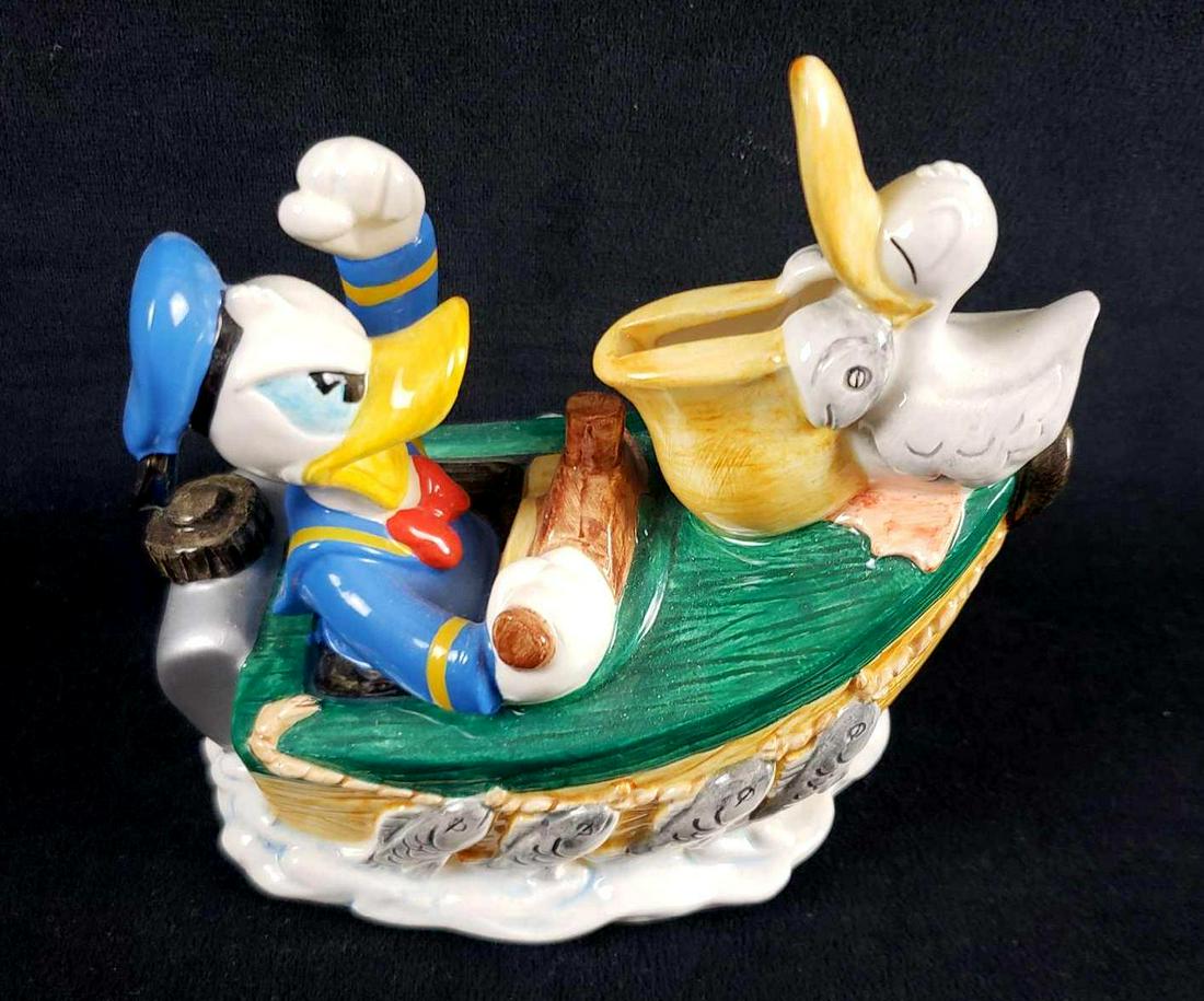 Vintage Ceramic Donald Duck Licensed by Enesco: Vintage Ceramic Donald Duck Licensed by Enesco Corporation Piggy Bank. This piggy bank is in great used condition. There are no known signs of damage to the piggy bank such as chips, cracks, or other