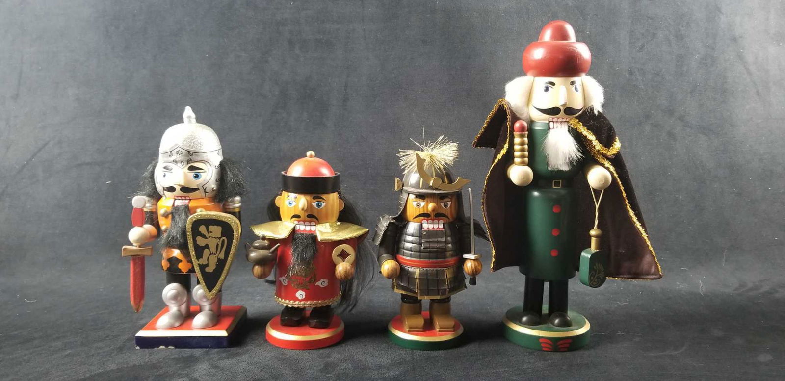 Ecelctic Warrior Asian Midevil Christmas Nutcracker Lot: This lot contains an eclectic mantra: 1- Orange, black, silver mid-evil knight with sward, shield, and armor. On a square base has some chips in the paint. Approx. measures 4 1/4" x 3" x 8 1/2" 1- 201
