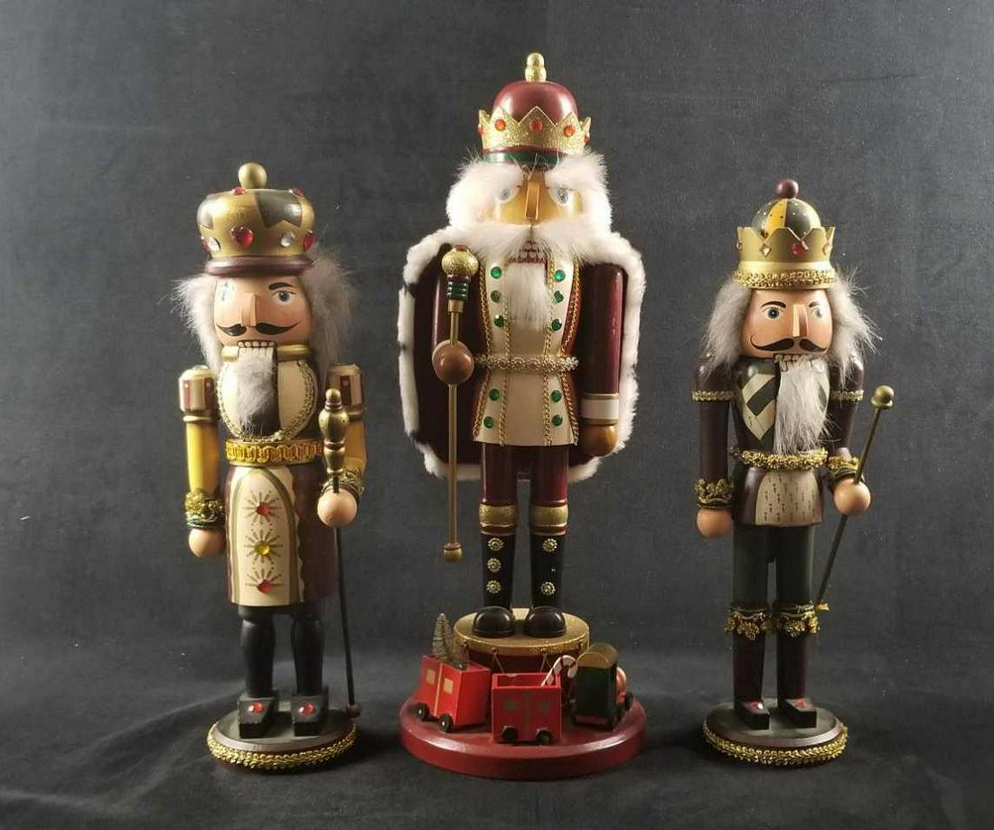 Royalty Court Kings of Christmas Nutcrackers Lot of 3: Royalty Court Kings of Christmas Nutcrackers Lot of 3 contains: 1- Dark red and white with gold chain trim design. Set on a round base on top of a drum and Christmas train in front. Missing some accen