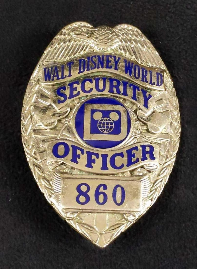 Vintage Rare Disney World Security Shirt Badge A: This badge adorned the shirt of the Walt Disney World Park Security Officer during the 1980s. Badge is approx 2 1/2" x 3". Is in good, used condition with some wearing on the front.