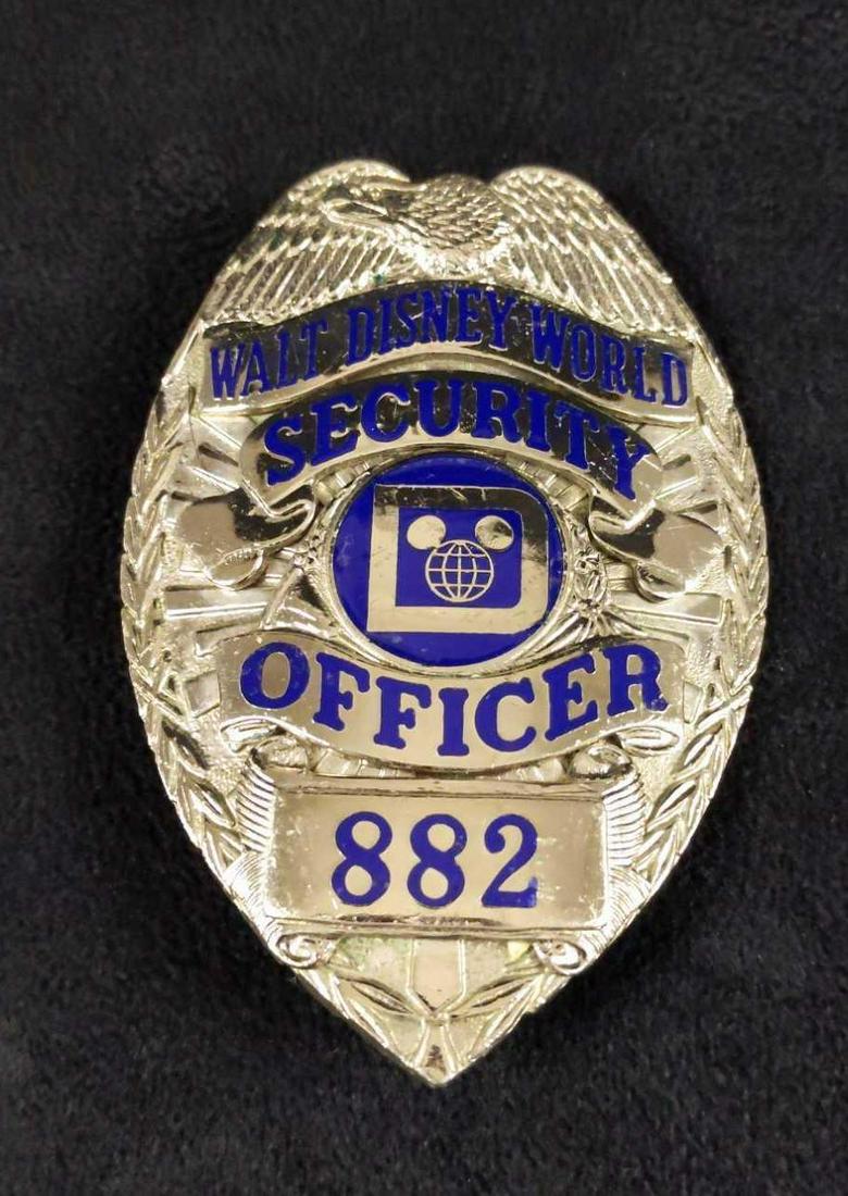 Vintage Rare Disney World Security Shirt Badge B: This badge adorned the shirt of the Walt Disney World Park Security Officer during the 1970s. Badge is approx 3" x 2".. Is in good, used condition with some wearing on the front and writing on the bac