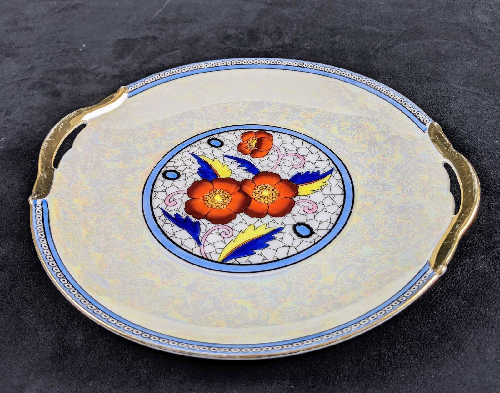 Hand Painted Porcelain Serving Plate: This is an serving plate made by Noritake that measures 10" across. It has a colorful floral pattern and painted with an Lusterware like color that gives off an unique shine. Measures approx 10" acros