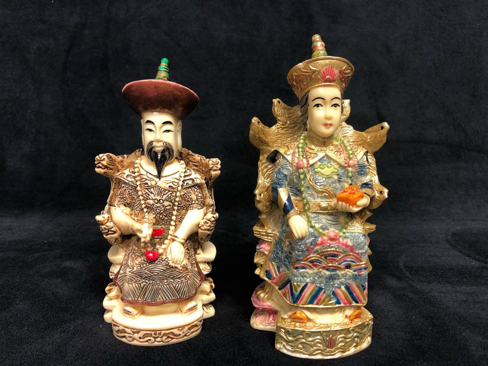 Chinese Empress Emperor Sitting Statues Figurines: The pair of hand-painted resin statues are of an Empress and Emperor sitting on his/her throne. There are no known chips or cracks. In great condition with no known scuff marks. The pair is stamped wi