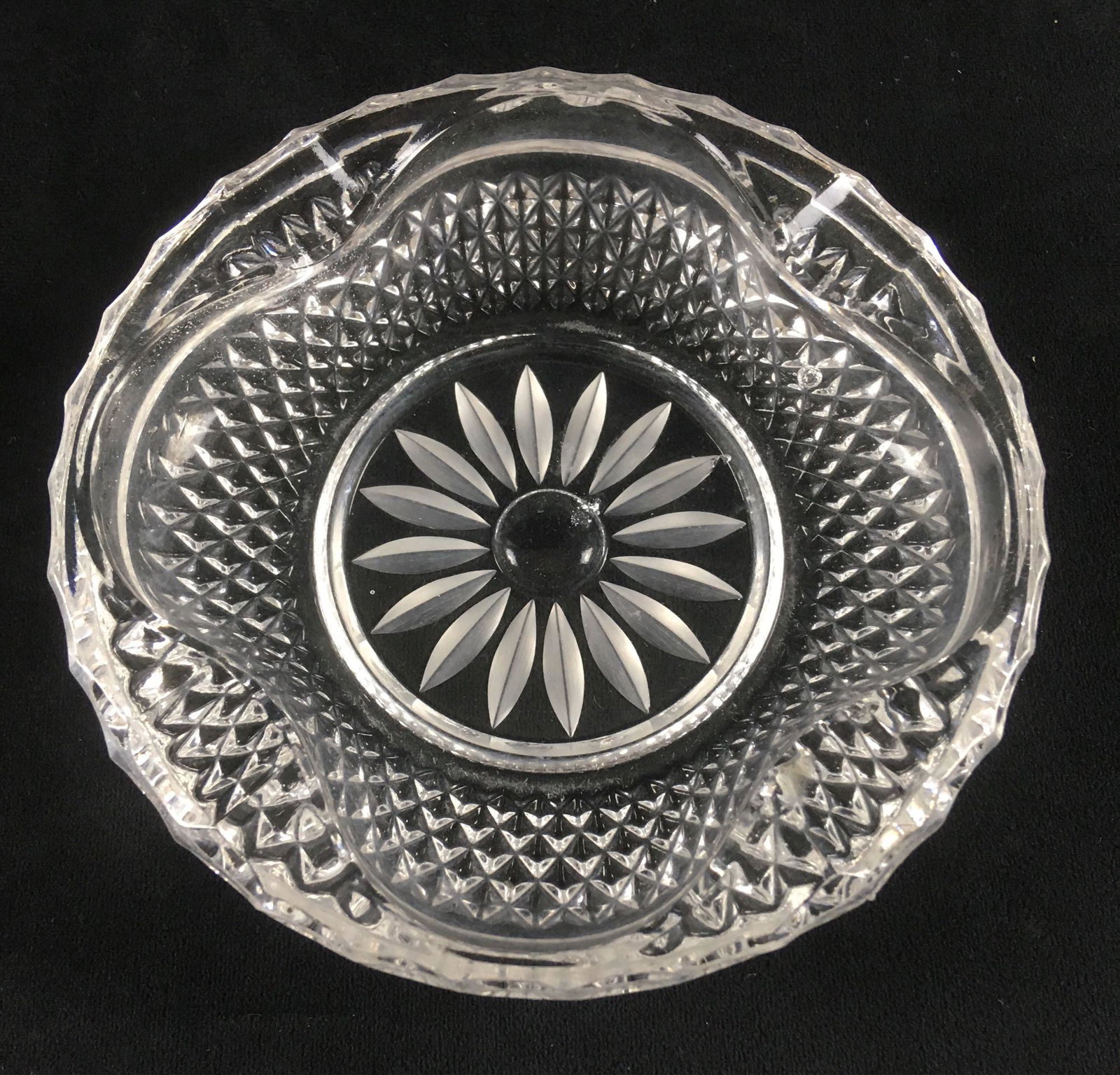 Vintage Cut Crystal Ashtray: Vintage Cut Crystal Ashtray; Features a star sunburst pattern on the bottom. It in excellent condition and measures about 1 1/4" H x 6" D.