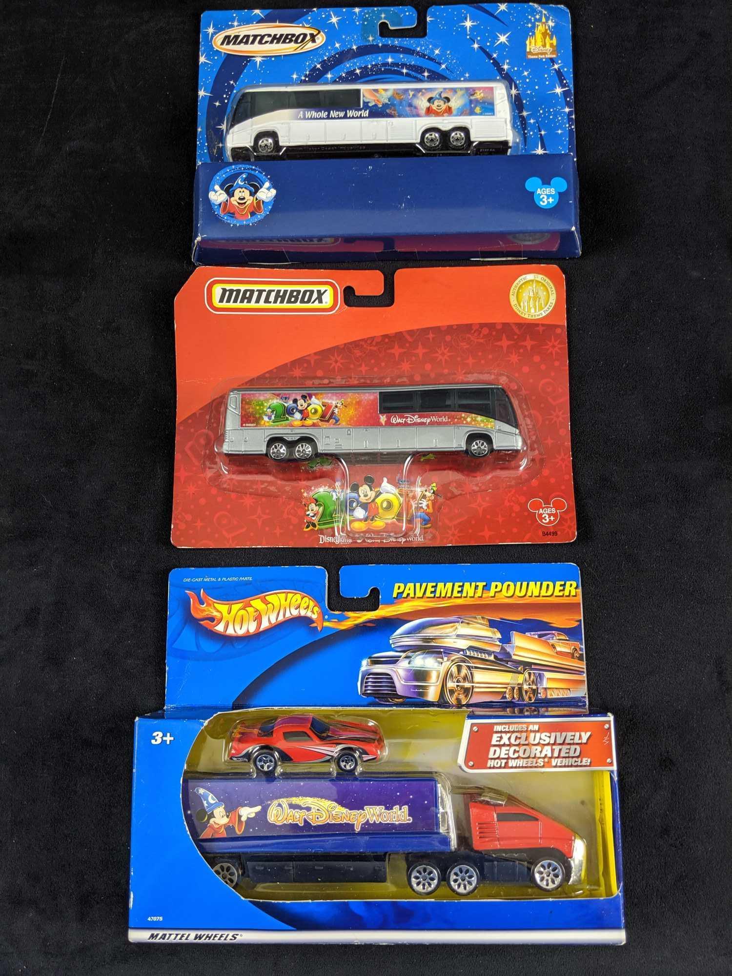 Disney Hot Wheels Matchbox Theme Park Die Cast Trucks: This lot includes: Matchbox 2003 "Whole New World" Disney bus, Matchbox 2006 "2007 Walt Disney World" bus and "Walt Disney World" Semi with bonus car. These are all mint in boxes and the boxes have so