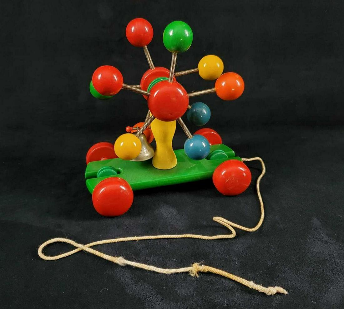 Vintage Kouvalias Greece Wooden Pull Toy With Bell: Vintage Kouvalias Wooden Pull Toy with Bell & Colorful Balls. Colorful wooden pull toy's Ferris/spinner like wheel turns as toy is pulled by string and this sounds a bell. Made is Greece. Is approx 8"