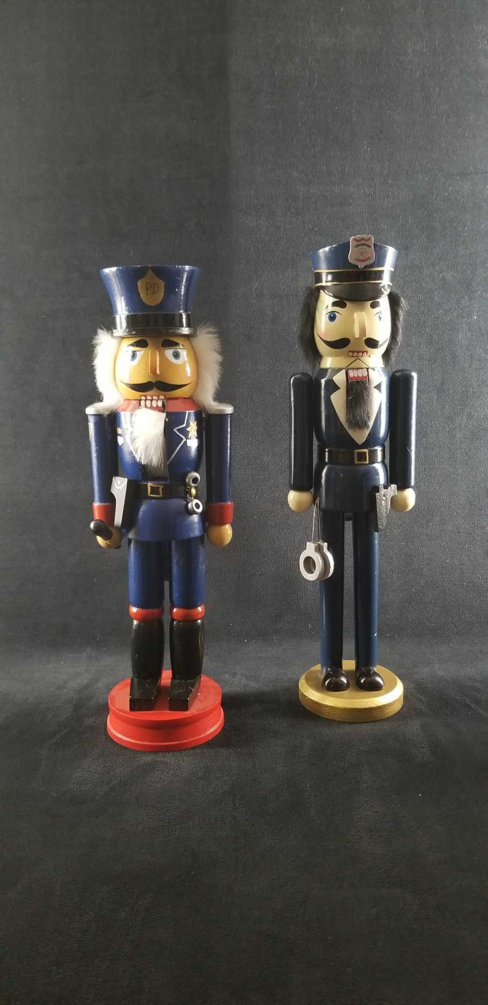 Law Enforcement Christmas Nutcracker Lot of 2: This lot contains: 2 wooden nutcrackers with fixed arms 1- Hobby Lobby marketed, gold base with solid blue uniform. Approx. measures 3 1/2" x 15" 1- Unknown maker with red base and red and blue unifor