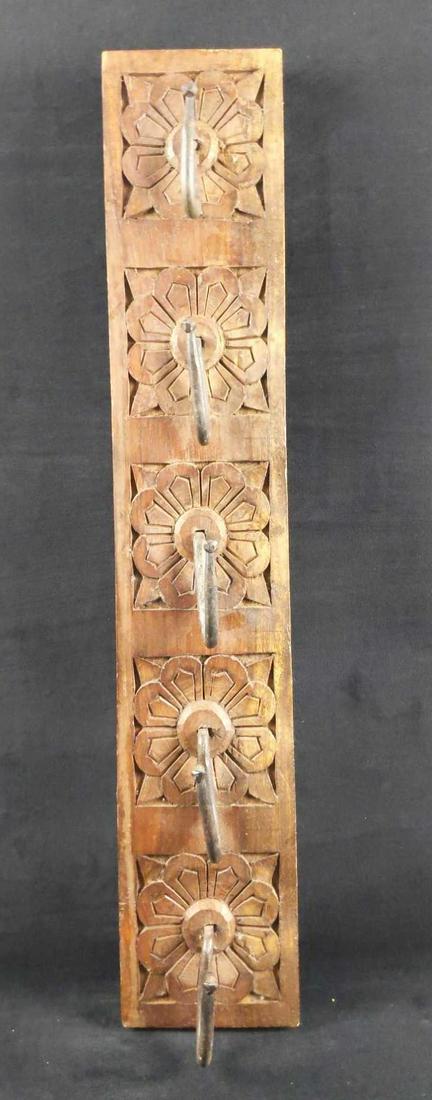 Solid Hand Carved Hat Keys Rack: Here is a hand-carved, solid wood hat rack with wrought iron hooks. It's perfect for caps or even keys. Rack is approx 4 1/2" x 1 1/2" x 25". The rack is in good, used condition light scratches on woo