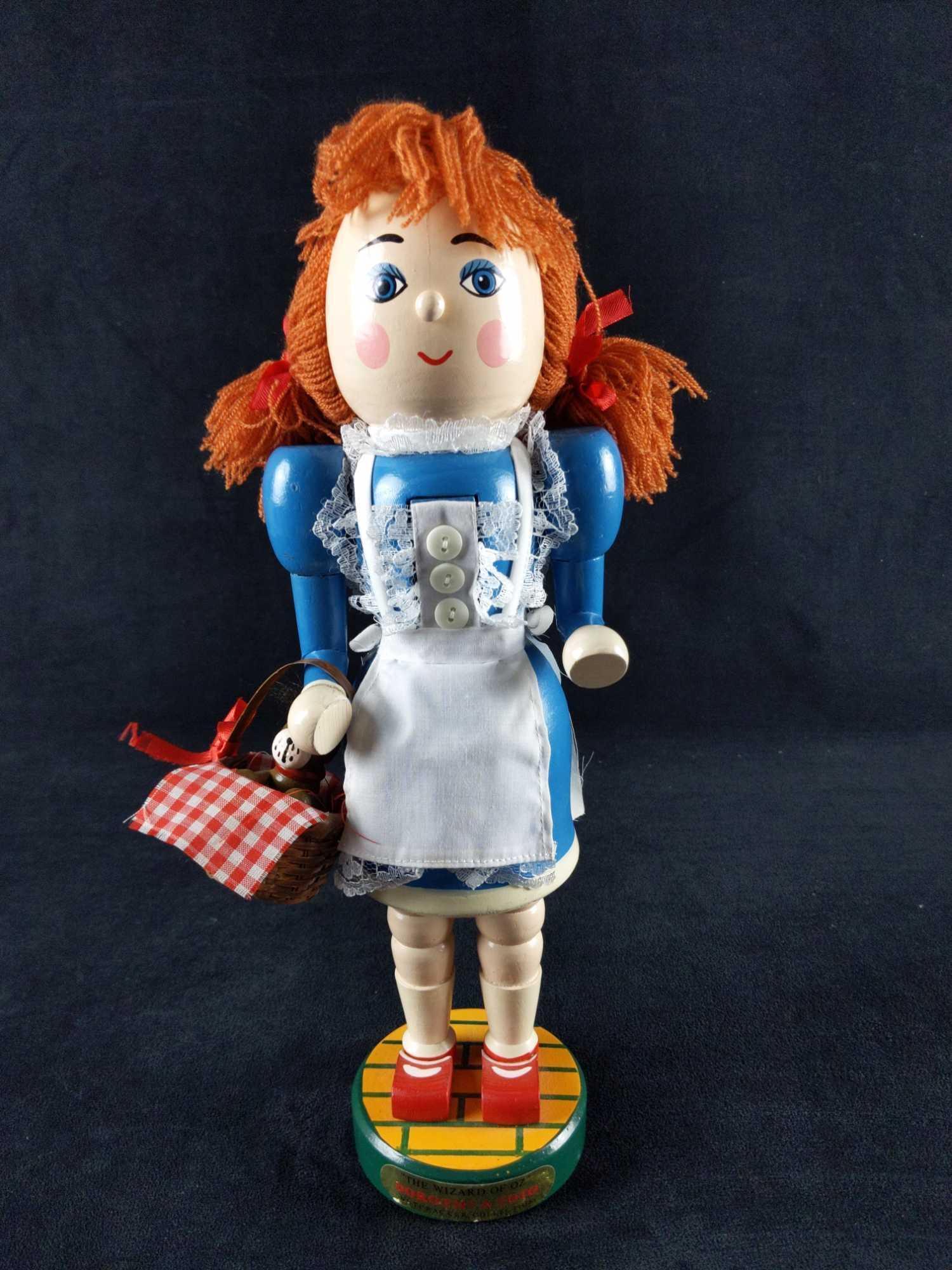 Kurt S Adler Wizard Of Oz Dorothy Wooden Nutcracker: Kurt S. Adler Wizard of Oz Wooden Nutcracker Dorothy and Toto. Is approx 4" x 4" x 14". Nutcracker is in good, used condition with a crack going down Dorothy's head and some wearing on her nose.