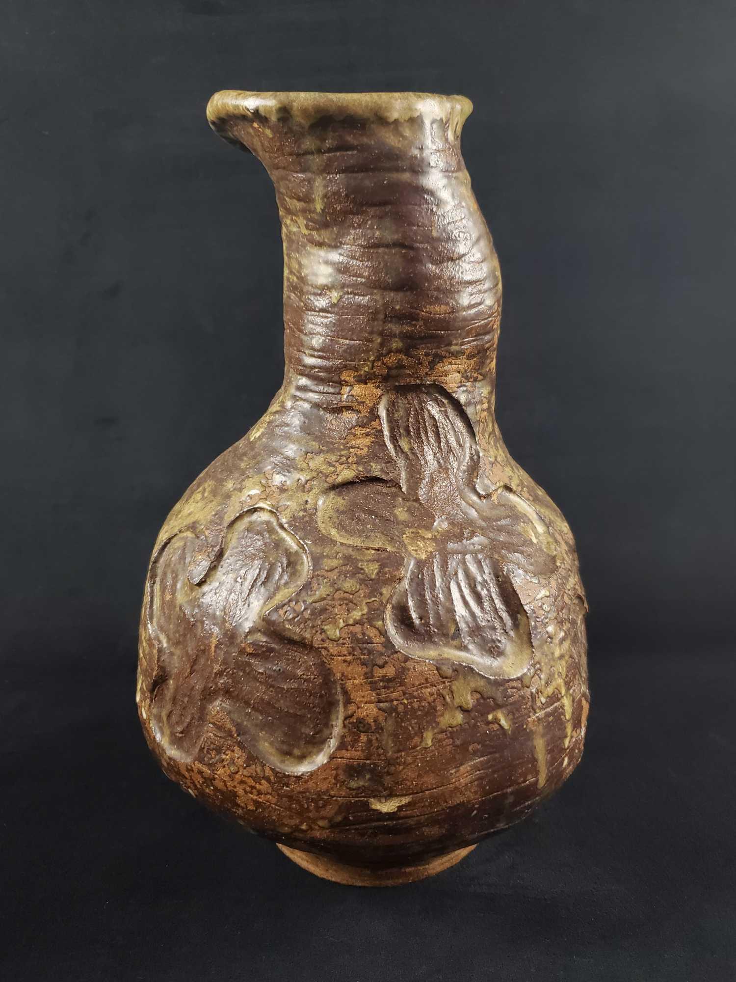 Large Vintage Hand Made Earthenware Clover Vase: Large clay pottery vase by "PC Perkiss" Dated 1971. Has clover like carved patterns and made from coils. Is approx 11" x 11" x 17". Vase is in good, vintage condition with no known damages.