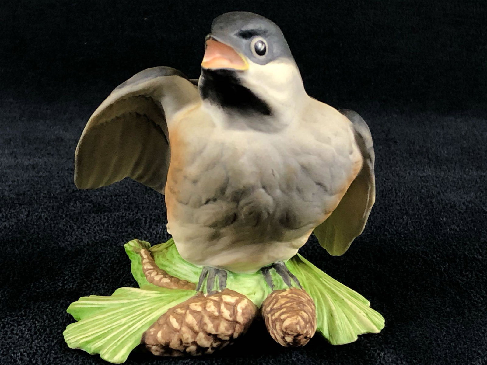 1960s Boehm Baby Chickadee 461 Boehm Birds Figurine: Vintage Boehm figurine Baby Chickadee 461 features a baby chickadee sitting on a pine tree branch stretching its wing. Hand painted porcelain made in the Boehm Porcelain studio in Trenton, New Jersey.