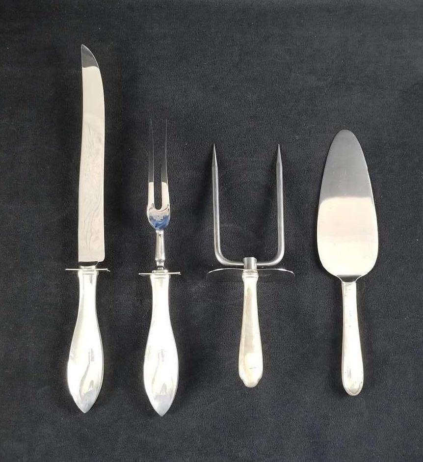 Sterling Silver Sheffield England Serving Flatware: This serving ware has stainless steel heads and Sterling Silver handles lot contains: 1- Sheffield marked Knife approx. measures 13" weight of 124.3g 1- Sheffield marked Fork approx. measures 10" weig