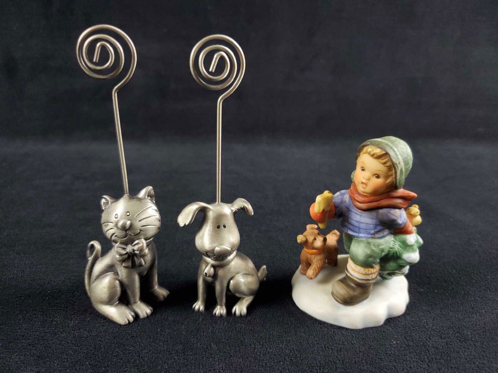 Pewter Dog And Cat Card Holder And Goebel Figure: Pewter dog and cat can hold a bushiness card, small photo, greeting card and more. Each figure is approx 2" x 4 1/2" and is in good, used condition with only minor wearing with no other known damage.