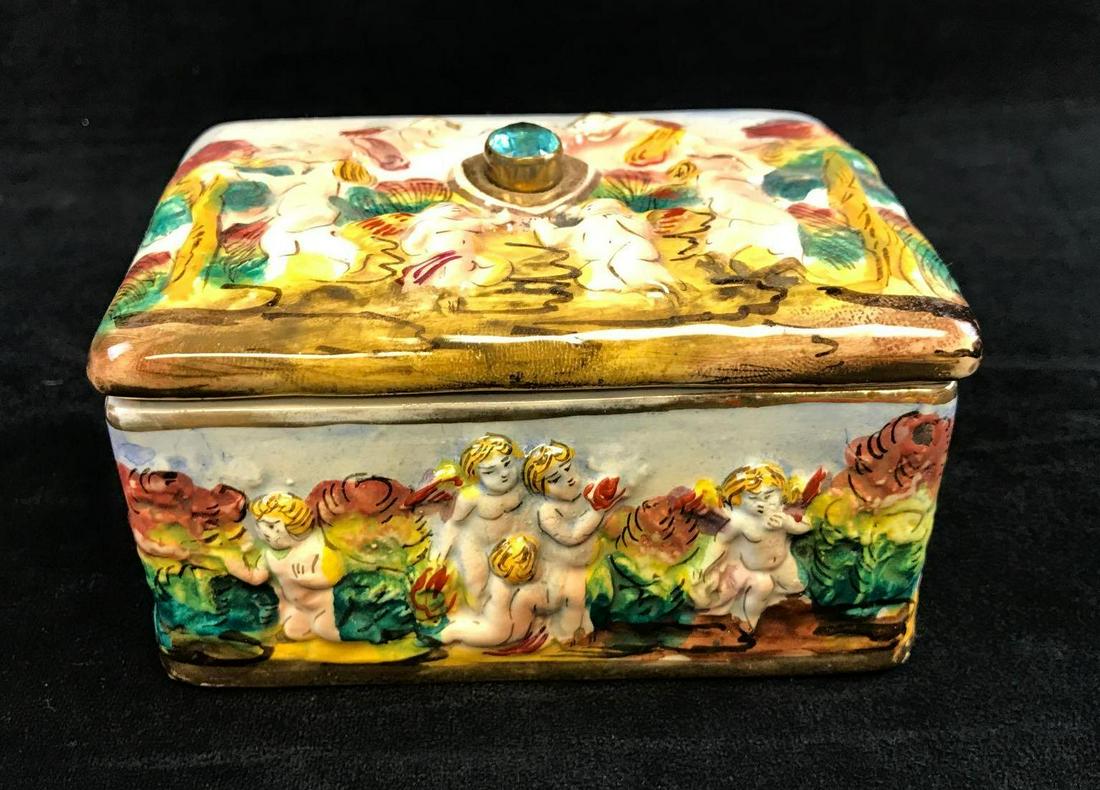 Ardalt Tesoro Capo Italy Hand Painted Trinket Box: Hand painted ceramic trinket box. Both the top and sides show textured, hand painted cherubs in a festive, floral scene. Made in Italy by Ardalt Tesoro Capo. Box is approx 5" x 4" x 3". Box is in good