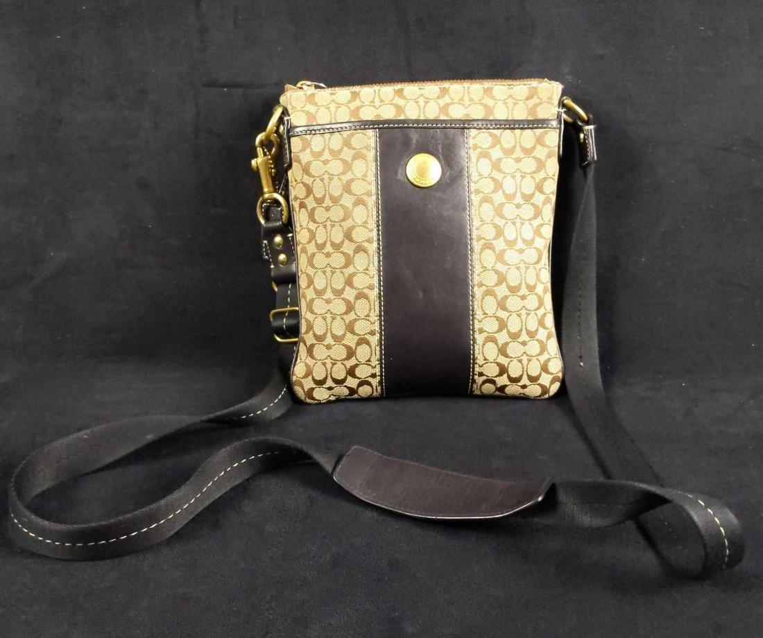 Coach Crossbody Bag W Signature Print Black Leather: Coach Cross-body Bag With Signature Print And Black Leather. The bag is approx 7" x 9". Shoulder straps are approx 22" long. Is in good, used condition with some wearing around Coach button.